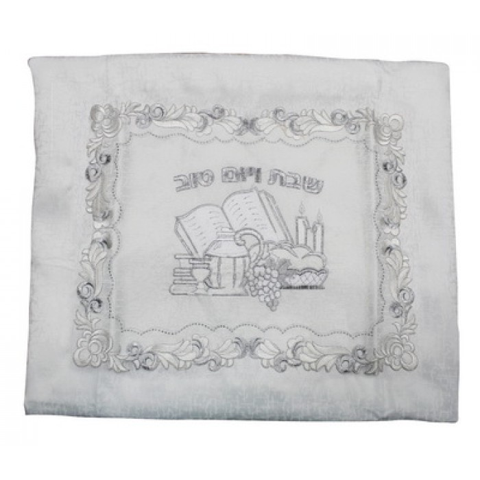 White Tablecloth with Silver Shabbat Items, Hebrew Text and Floral Pattern